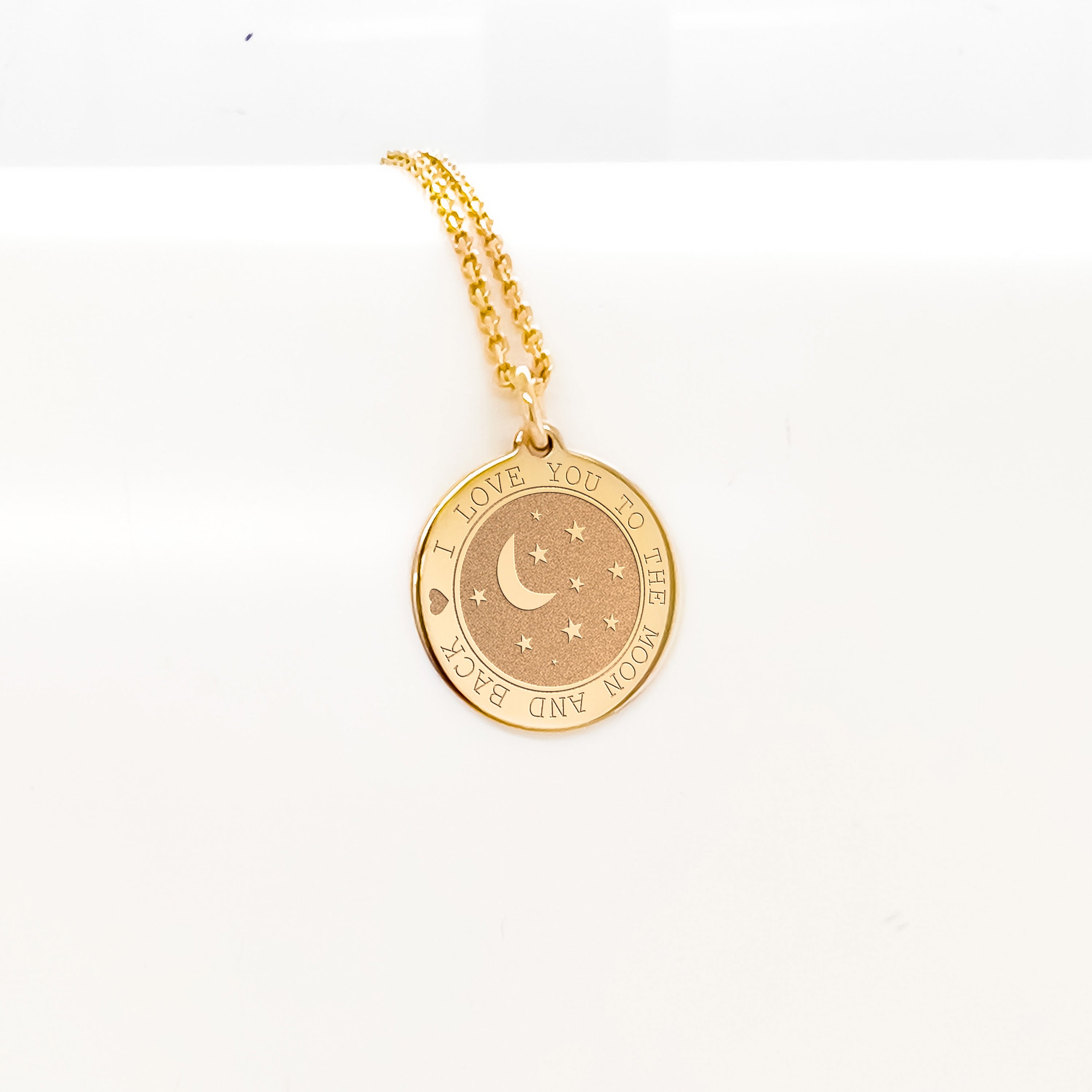 a gold necklace with a crescent and stars on it
