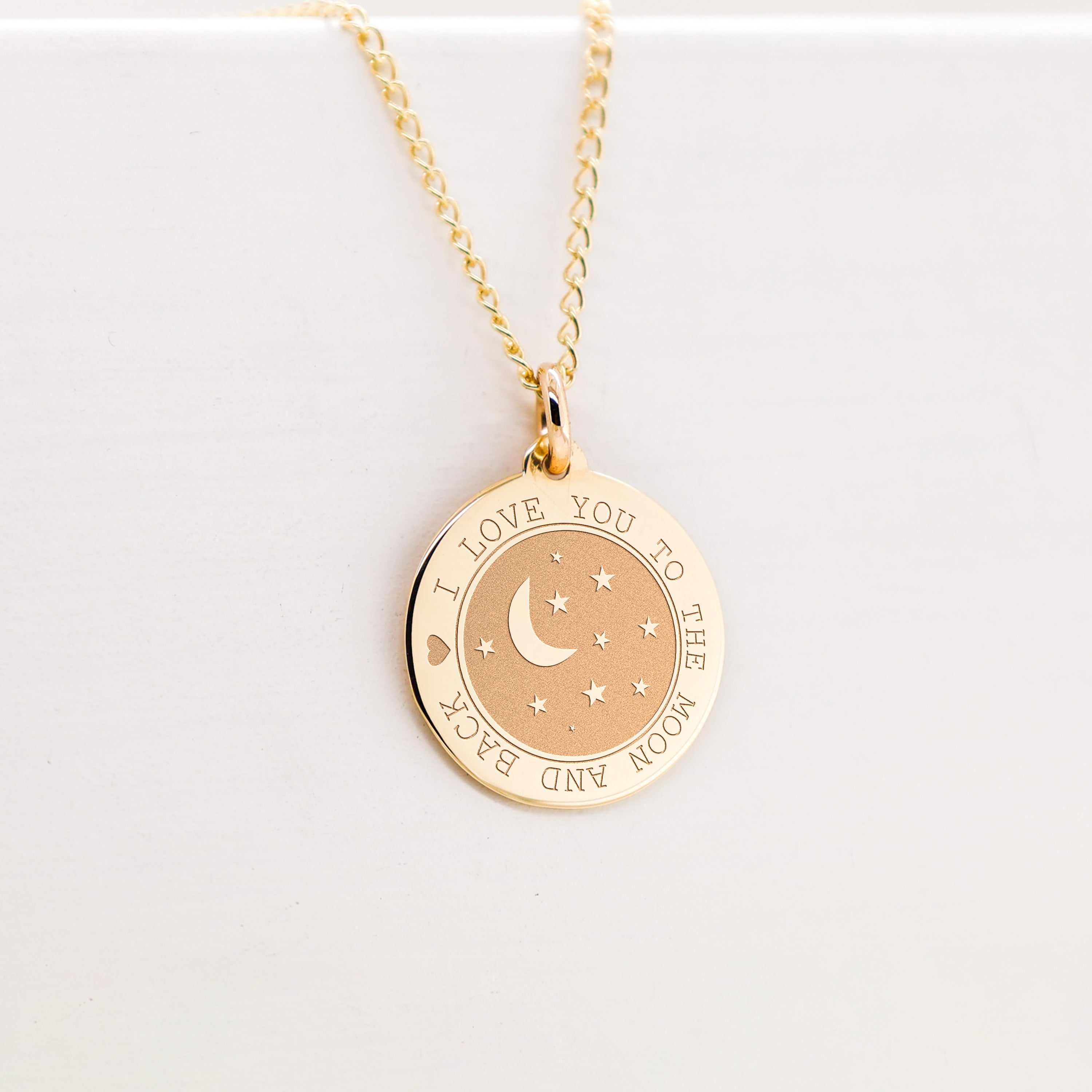 a gold necklace with a crescent and stars on it
