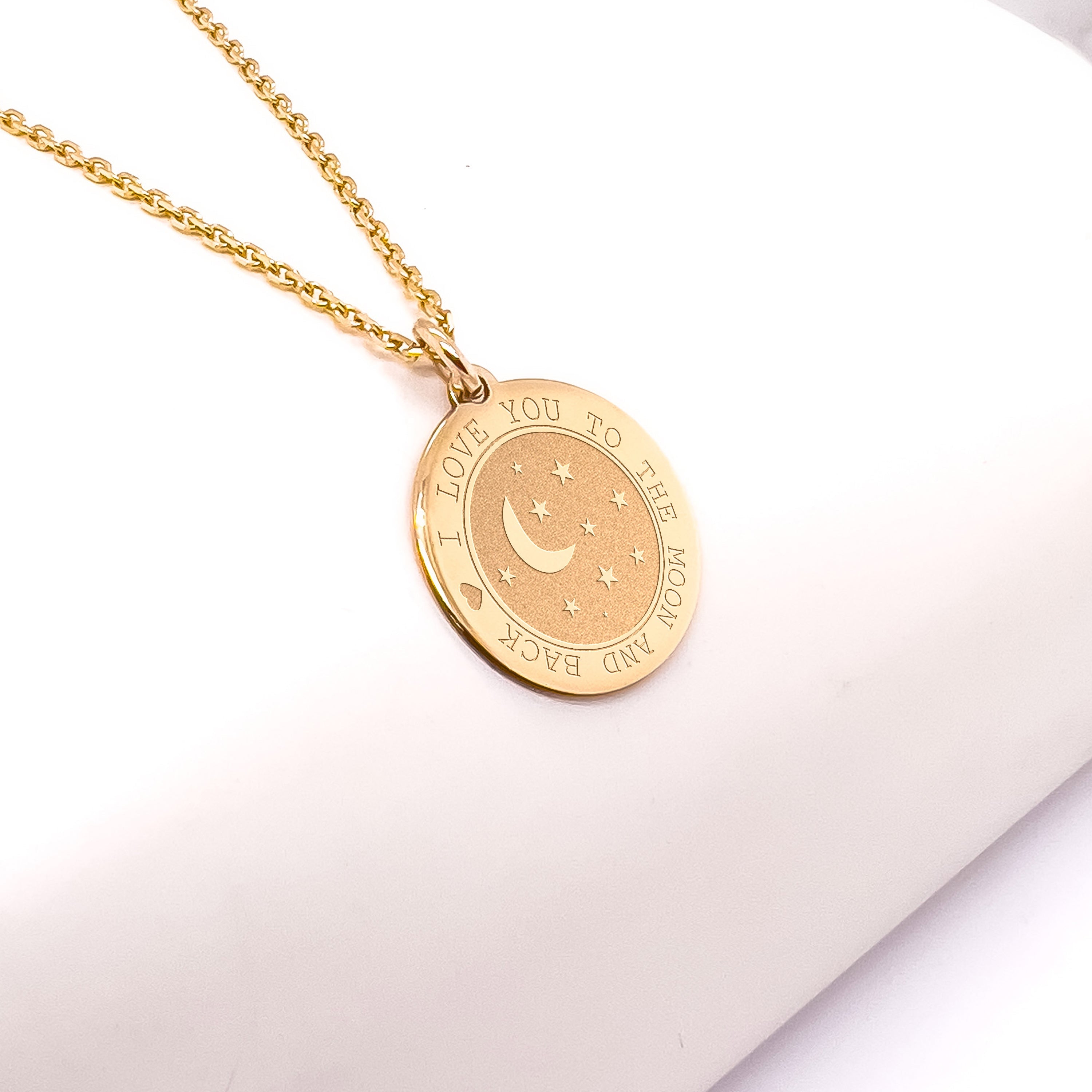 a gold necklace with a crescent and stars on it